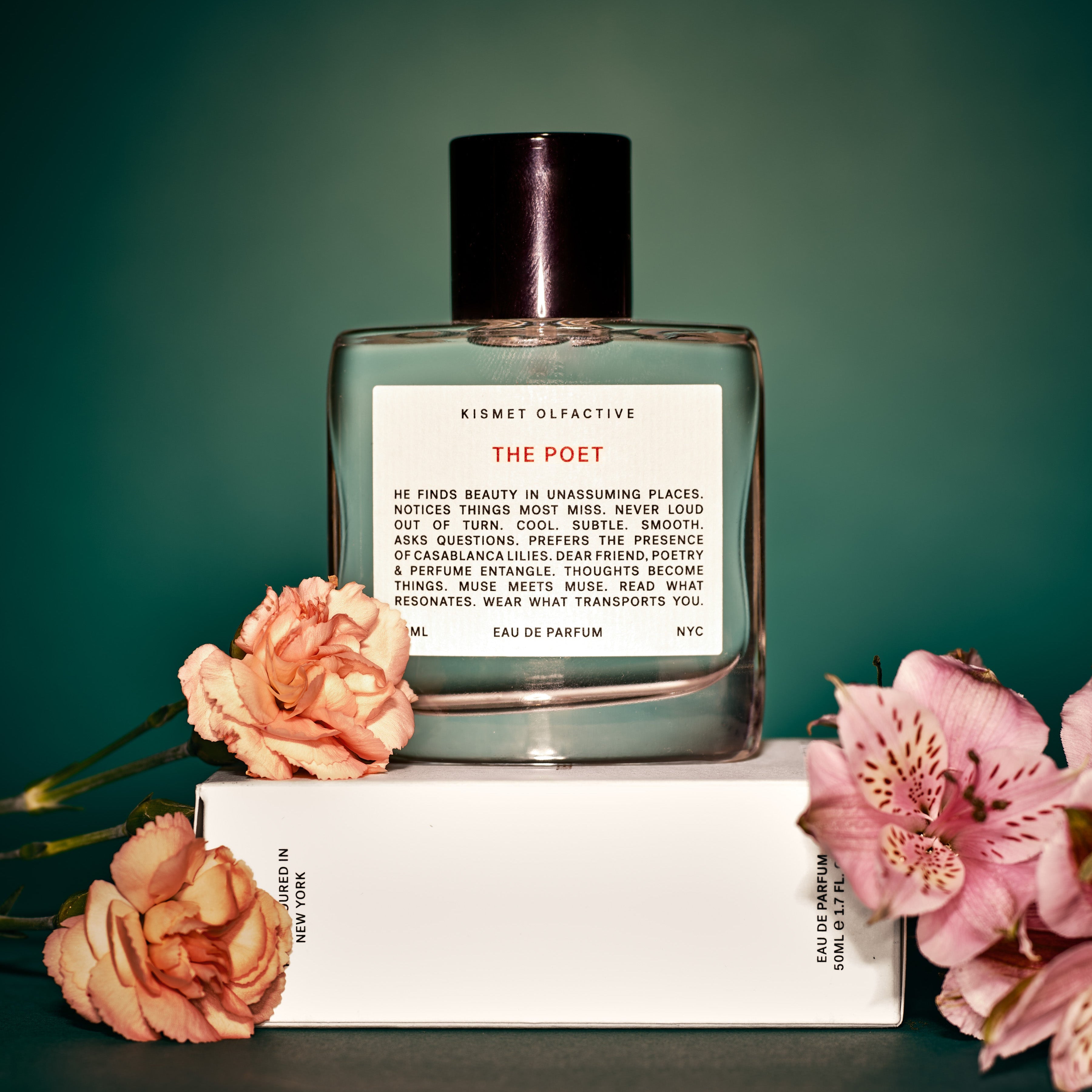 Perfume bottle labeled 'The Poet' with flowers on a green background by Kismet Olfactive